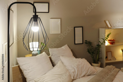 Glowing lamp in bedroom at ...