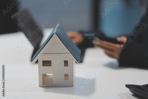 Wallpaper Mural Real estate agents explain models of housing estates in projects to elaborate to clients, explaining and presenting information about homes and purchasing loans. Real estate trading concept. Torontodigital.ca