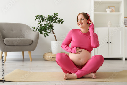 Pregnant woman in pink acti...