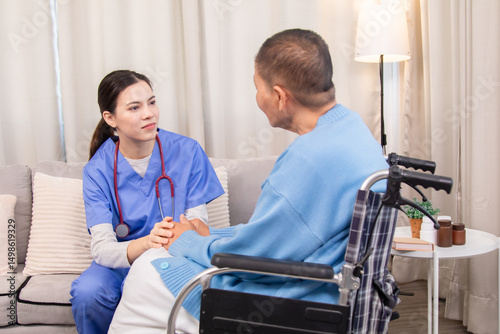Senior woman in wheelchair discussing health with nurse on sofa, both smiling and sharing emotional connection, illustrating trust and support in home care setting, healthcare, illness, patient.