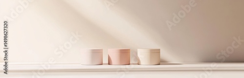 A serene display of three minimalist cream jars in soft colors on a light surface, creating a calm atmosphere with elegant shadows. Perfect for beauty branding.