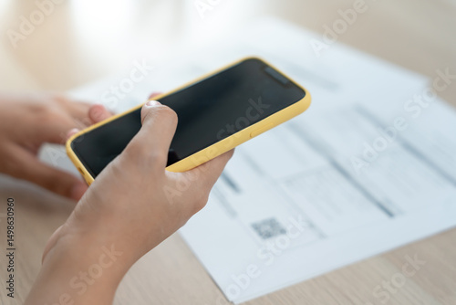 use phone to scan barcode or QR codes to pay credit card bill after receiving document invoice online. payment, receive, paying electricity, payments, technology, scanning, financial transactions