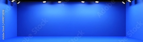 Blue studio backdrop, lights, empty