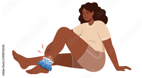Young woman sitting with ice pack on injured ankle at home  