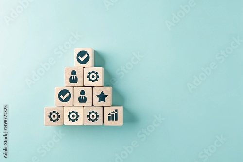 A pyramid structure made of wooden blocks, each containing different icons. The top block has a checkmark, while the lower blocks have various symbols related to processes or tasks