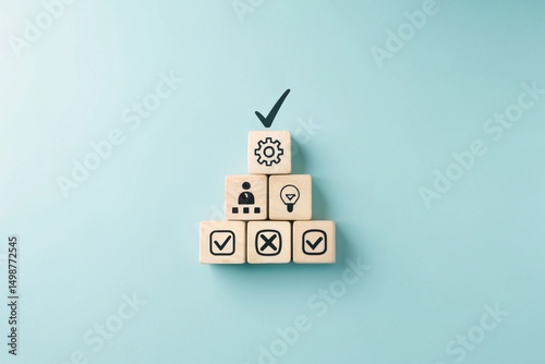 A pyramid structure made of wooden blocks, each containing different icons. The top block has a checkmark, while the lower blocks have various symbols related to processes or tasks