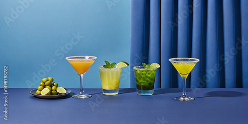 Bright and refreshing cocktails lined up with garnishes and limes on a blue table, perfect for bar menus, summer party themes, or beverage promotions.