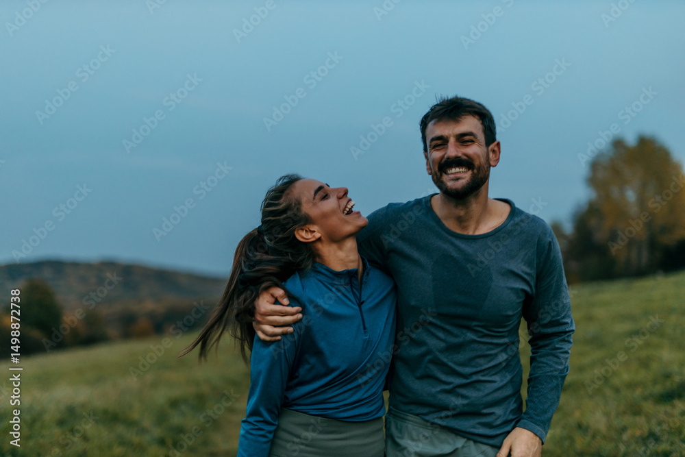 Happy couple laughing and enjoying nature during hiking trip Happy couple laughing and enjoying nature during hiking trip
