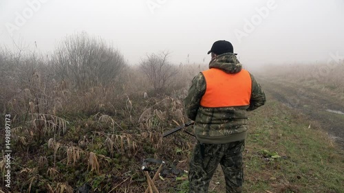 Hunter in foggy landscape prepares for a day of game tracking near Begec