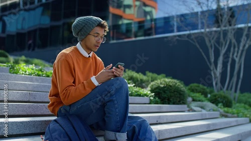 Upset student reading exam results on phone
