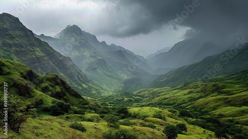A lush green valley nestled between mountains under a moody sky, with rain showers creating a dramatic monsoon atmosphere.
