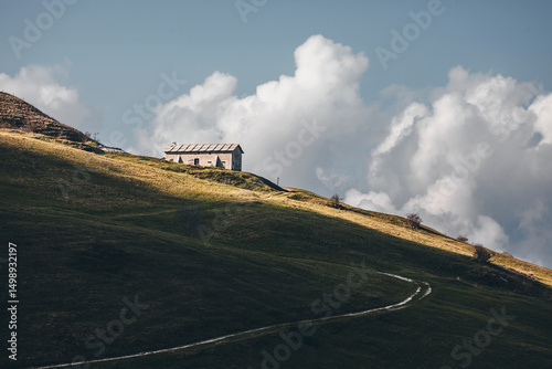 Old stone hut in the Lessini Mountains, Veneto, Italy, with colorful beech forests in peak foliage, soft mountain fog, golden leaves, and a peaceful, atmospheric woodland scenery.