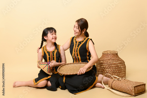 Fotografie Beautiful kadazandusun native mother and daughter in traditional costume isolate