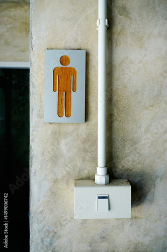 Men toilet sign at wall with switch