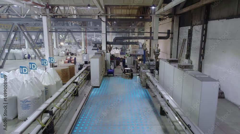 Production line and equipment for manufacturing wired electrical wire in a factory workshop. Automated conveyor in cable plant. Production of electrical cable. Smart factory concept.