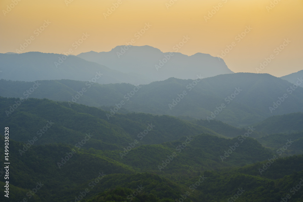 Breathtaking mountain landscape sunset, showcasing layered hills and warm golden sky. serene atmosphere evokes tranquility Breathtaking mountain landscape sunset, showcasing layered hills and warm golden sky. serene atmosphere evokes tranquility