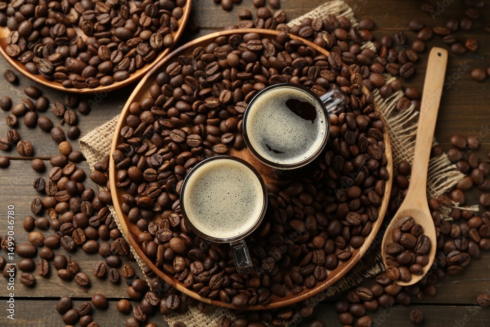 Fototapeta premium Aromatic coffee in cups and beans on table, flat lay