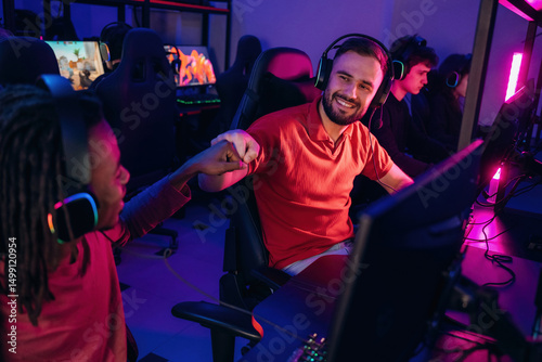 Victory, nice job, hands gestures. Gamers are playing video game by computers