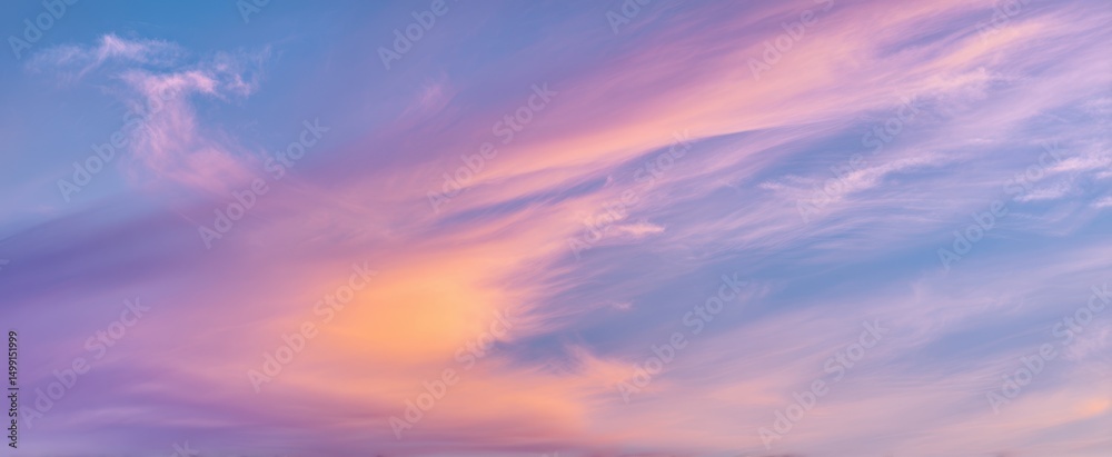 Fototapeta premium The beautiful gradient sky adorned with pastel-colored clouds at sunset
