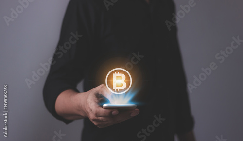 Young man using smartphone hand touching to trade cryptocurrencies online, Investors in cryptocurrencies and bitcoin coins online