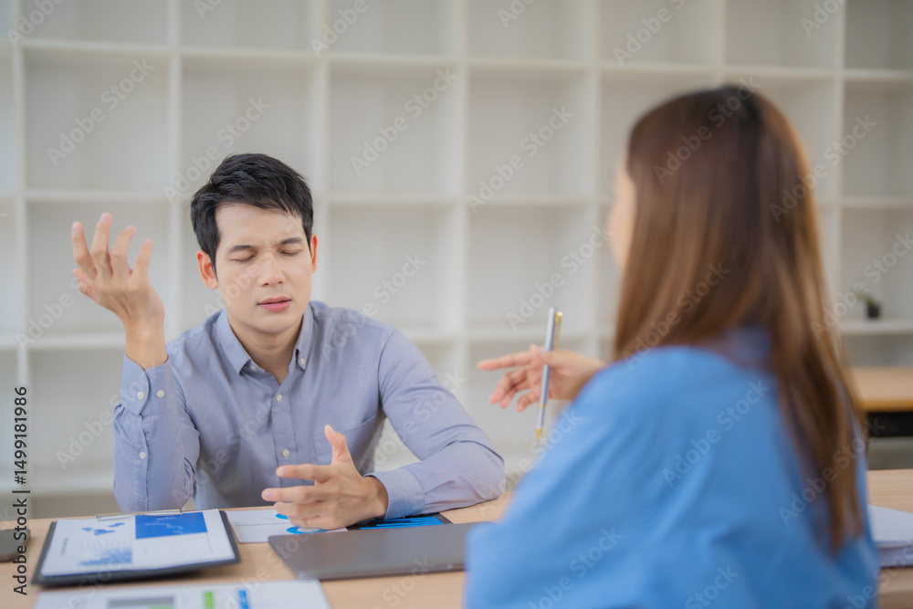 Two asian businesspeople discussing about negative financial report, businessman is stressed and gesturing with hands while having a difficult conversation with his colleague Two asian businesspeople discussing about negative financial report, businessman is stressed and gesturing with hands while having a difficult conversation with his colleague