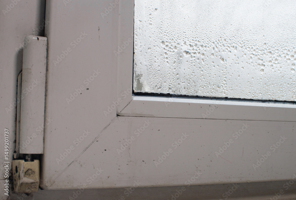the fogged window. drops on the window glass the fogged window. drops on the window glass