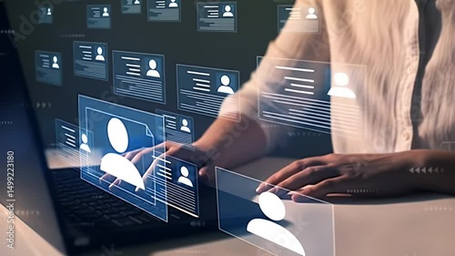 Woman Typing On Laptop Near Digital Resume Screen With Blue Accents In Dim Room for Human Resources And Recruitment Concept