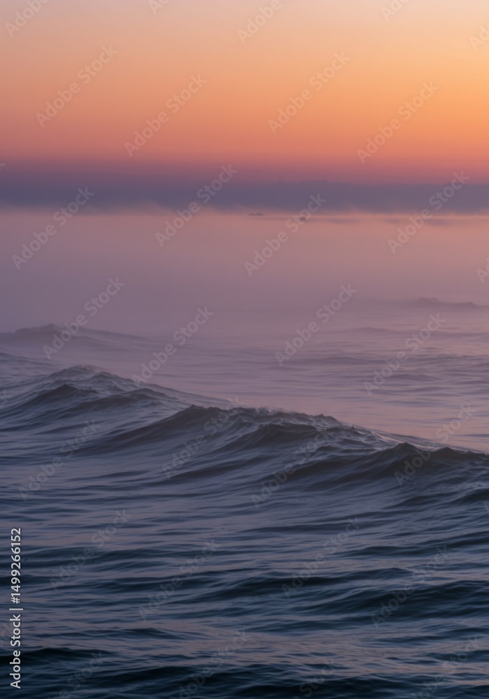 Obraz premium Pink and Purple Sunset over Misty Ocean Waves
