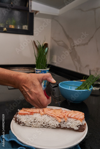hands making fresh sushi at home