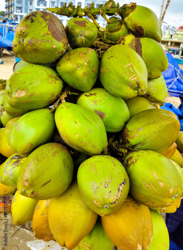 Green Fresh Coconut Partially Consumed for Natural Hydration and Tropical Refreshment Concepts