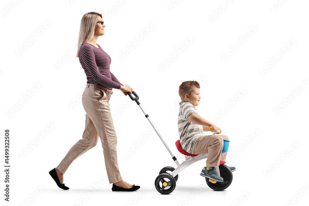 Mother pushing son on a tricycle Mother pushing son on a tricycle