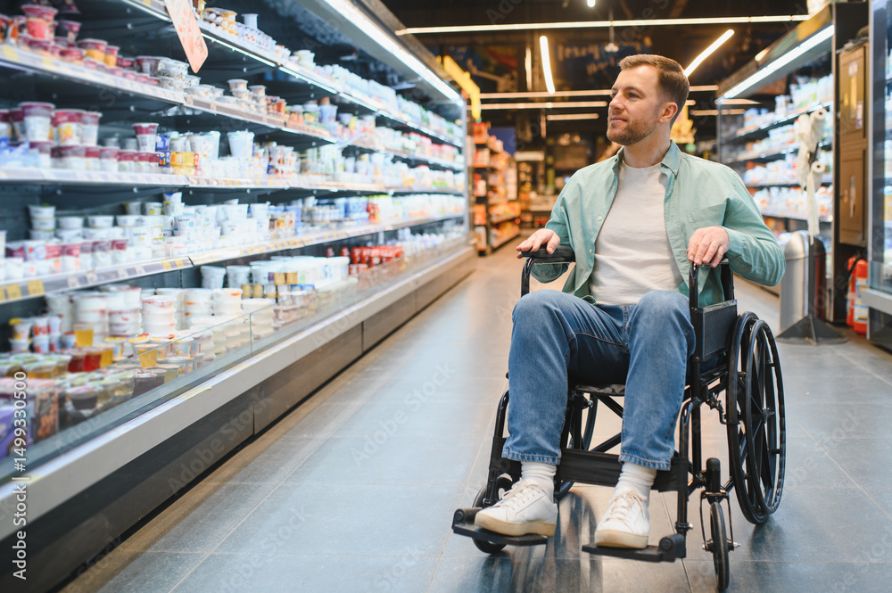 Obraz premium Customer using wheelchair choosing products in supermarket dairy section