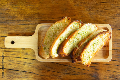 Garlic bread on wooden plate, Cooking concept.