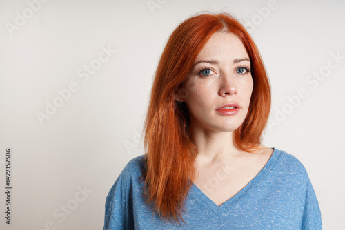 portrait of 30 year old woman with dyed red hair and blue eyes