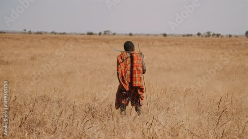 Maasai Warrior Walking Through Savanna