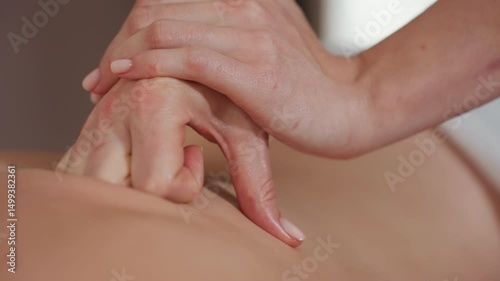 Wallpaper Mural Close-up of massage therapist using slightly folded hands to apply pressure on woman back during professional treatment session, with blurred client face and focus on therapeutic hand technique Torontodigital.ca