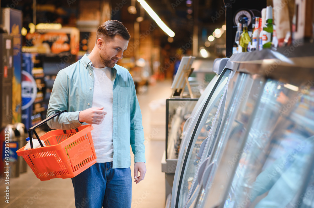 Obraz premium Customer choosing products in refrigerated section of supermarket