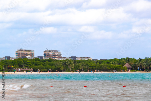 Fototapeta Naklejka Na Ścianę i Meble -  Tropical Caribbean beach people parasols fun Playa del Carmen Mexico.