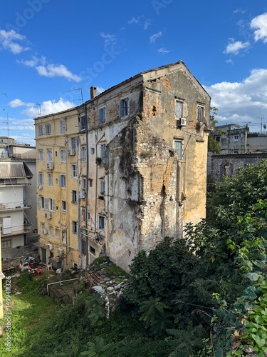 Fototapeta Naklejka Na Ścianę i Meble -  Golden hour view of Corfu Town (Kerkyra) on the island of Corfu, Greece. Warm sunlight bathes the historic buildings, narrow streets, and coastal architecture, highlighting the charm of this Mediterra