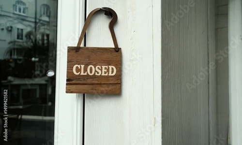 Wooden closed signboard hanging at cafe or restaurant entrance with minimalist and cozy atmosphere