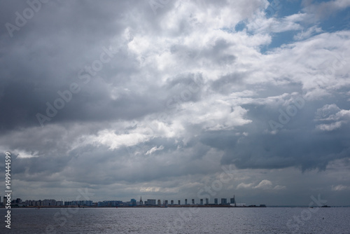 Fototapeta Naklejka Na Ścianę i Meble -  Landscape of the Gulf of Finland in St. Petersburg. Dramatic clouds over the water surface of the Baltic Sea.
