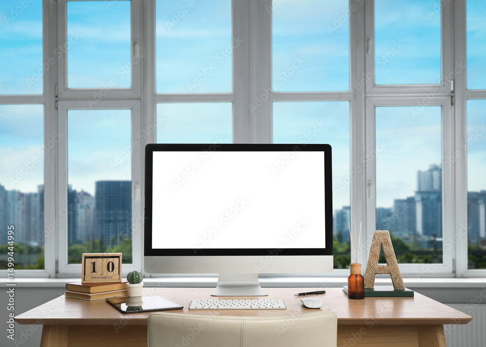 Fototapeta premium Workplace with modern computer near city view window in office