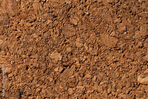 Close-up with shallow depth of field. Surface of pressed cork wood. Orange warm background