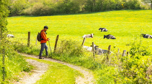 an asian man visiting a rolling terrain farm in Aachen, Germany