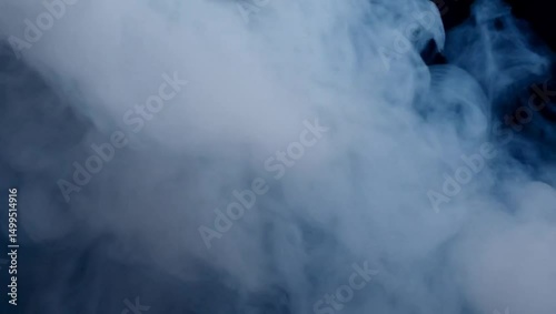 Liquid Smoke Patterns: Ethereal Clouds in Motion Against a Dark Background
