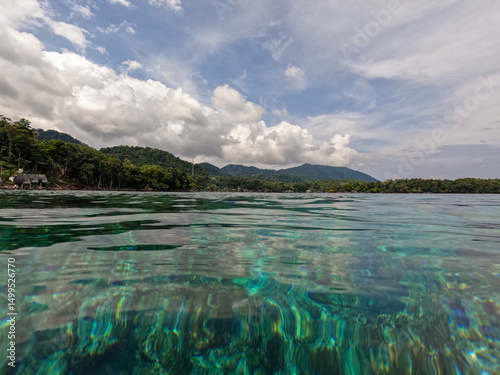 Scenic ocean view of turquoise crystal clear water over coral reef on tropical island of Pulau Weh in northwest of Sumatra Indonesia