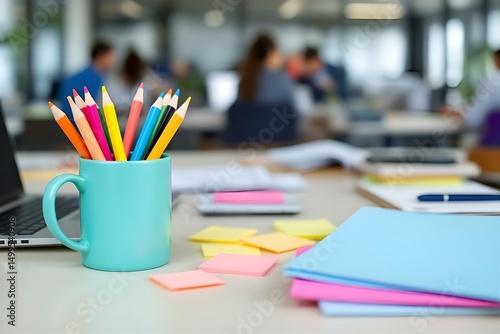 Colorful Pencils in Mug on Office Desk: Workspace with Laptop, Sticky Notes & Stationery for Creative Work & Organization