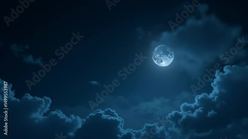 Bright full moon shining through clouds in a dark night sky  