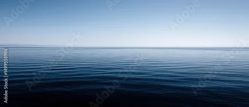 Panel kuchenny z motywem Calm blue ocean water with gentle ripples under a clear sky in a serene landscape view from a high angle perspective