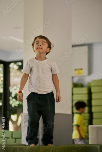 Little boy plating in the indoor kids club.